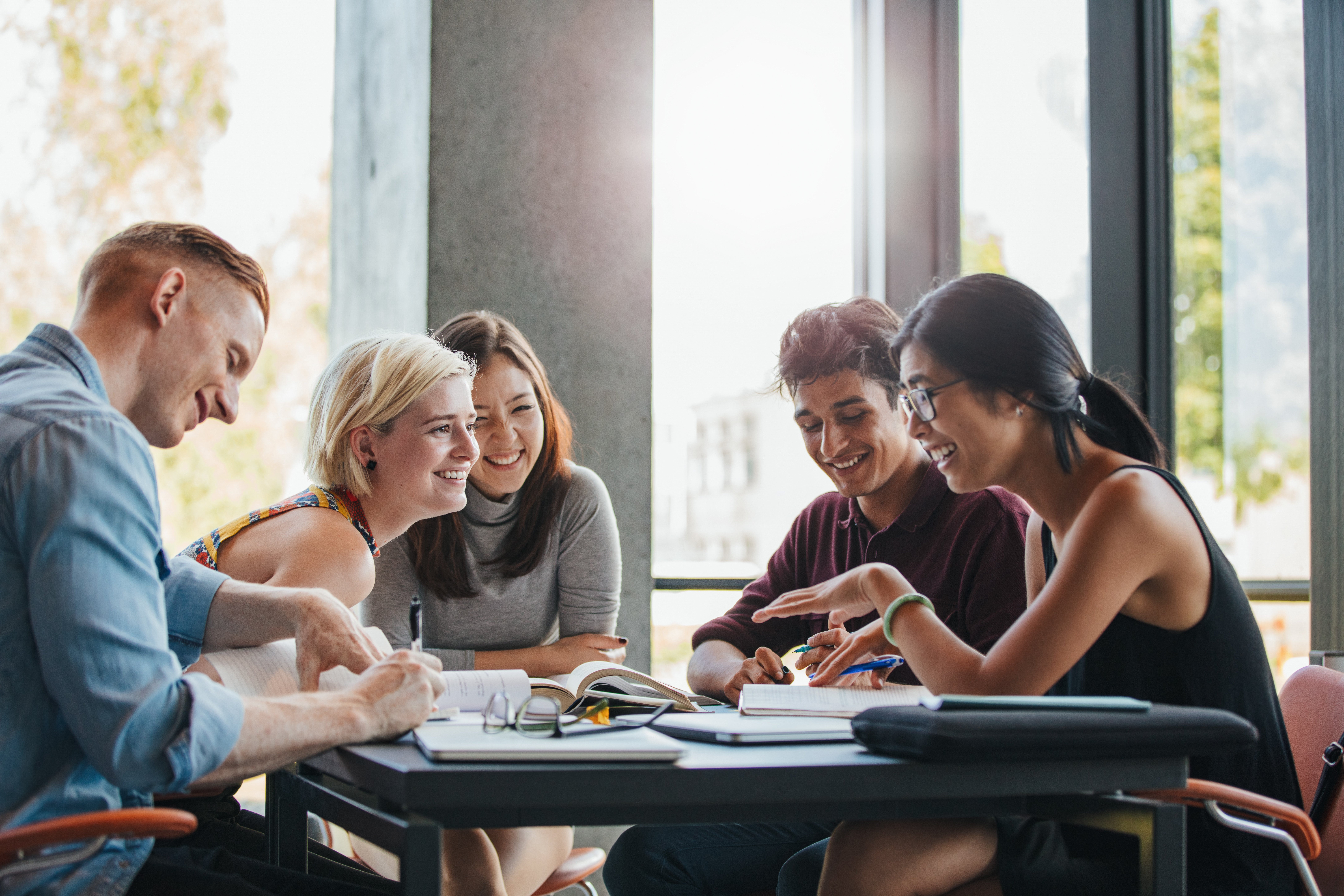 A group of young people studying and talking