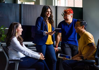 Group of young people talking in an office 