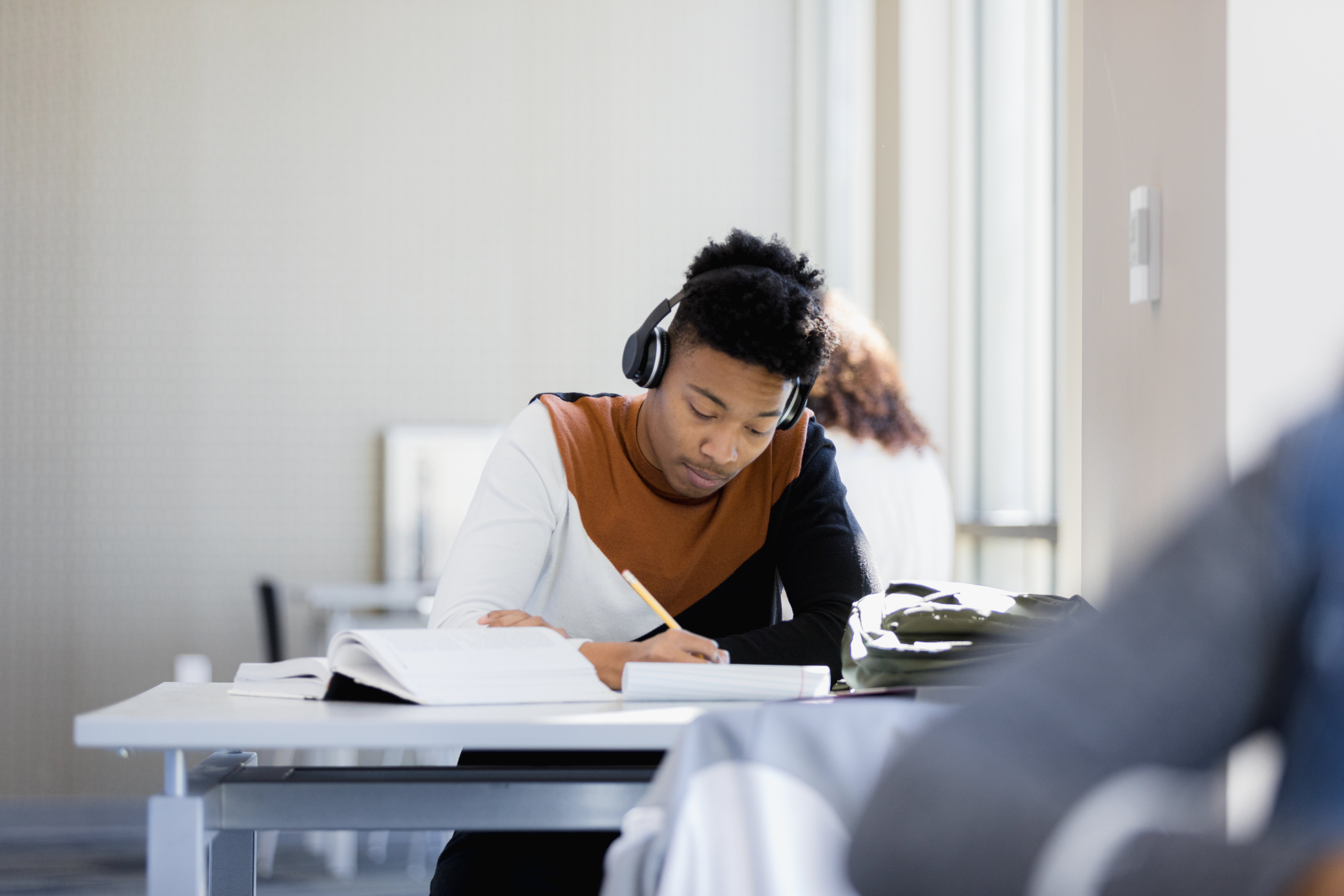 Young man studying with headphones  