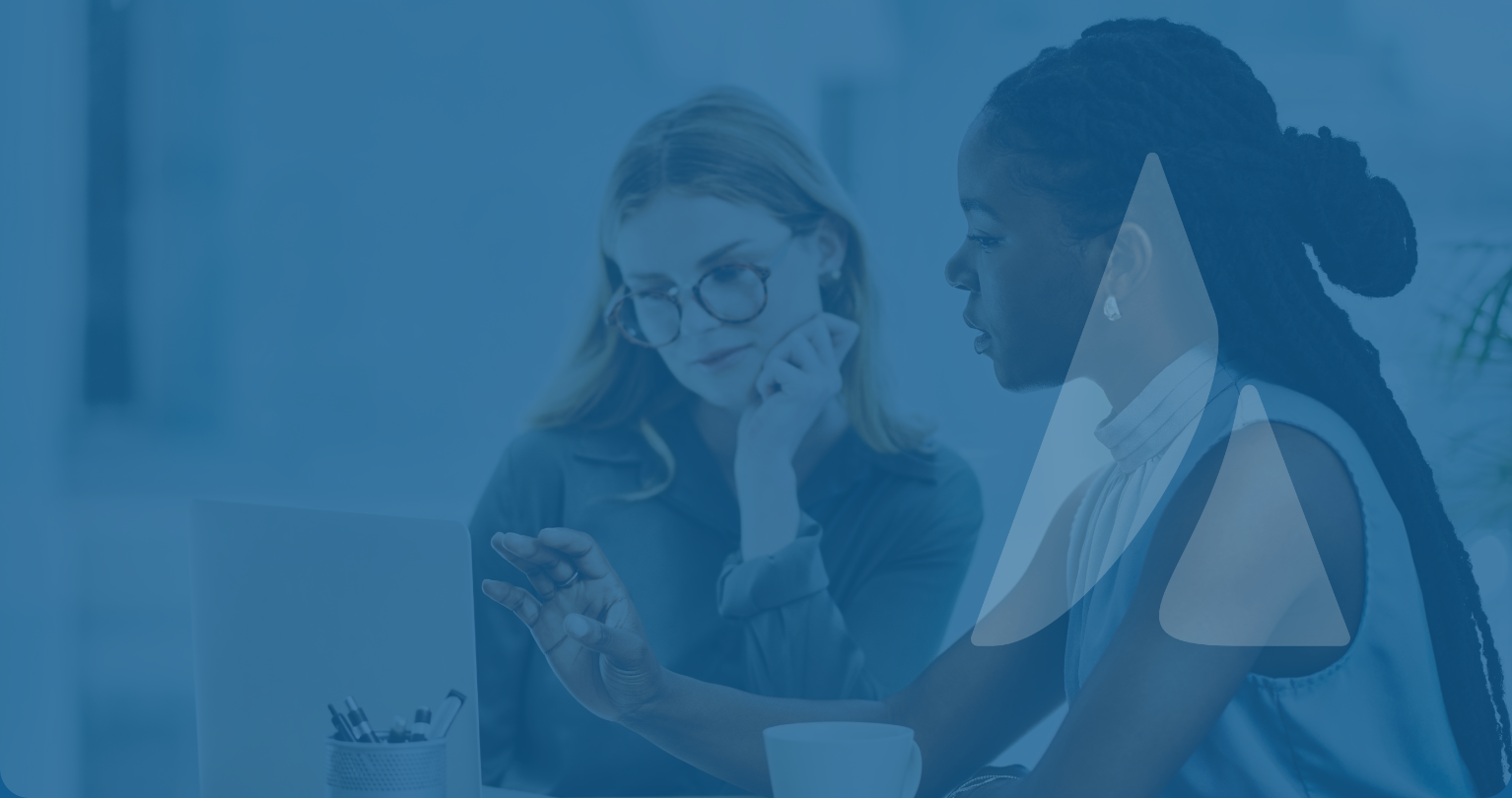  Two women collaborating while utilizing Ad Astra's services, including strategic consulting, software implementation, and on-demand training for higher education success.